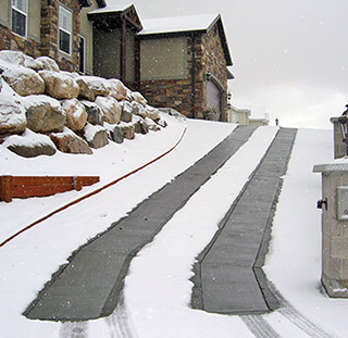 Electric heated driveway system installed in concrete driveway.