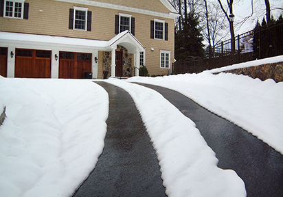 Heated asphalt driveway with heated tire tracks.