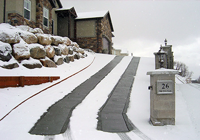 Heated driveway on incline with heated tire tracks.