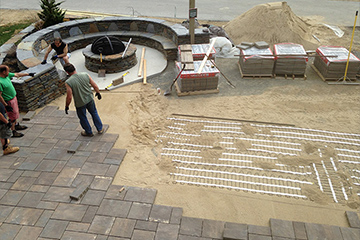 Installing a heated paver driveway.