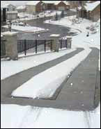 A steep driveway with heated tire tracks.