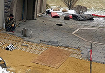 Radiant heat cable installed under brick pavers for driveway heating system.