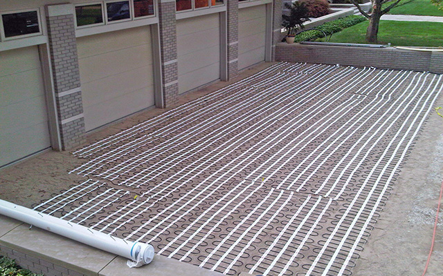 Installing a heated paver driveway.